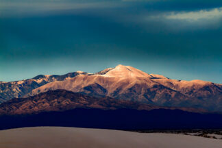 The beautiful snowy Sierra Blanca Peak was seen from White Sands National Monument in the evening sun.