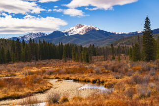 Snowy Byers Peak overlooks a meadow of late autumn colors near Fraser, Colorado.