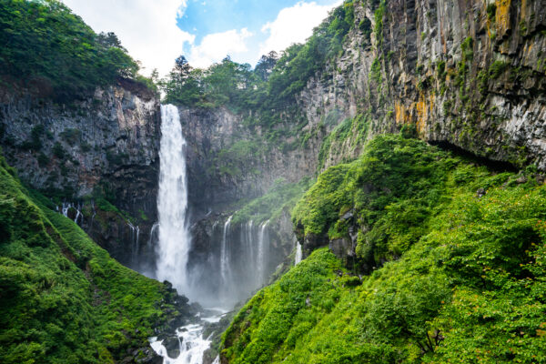 Lush greenery decorates Kegon Falls in Tochigi prefecture in Japan. The falls were splashing cool mist on a humid hot summer day.