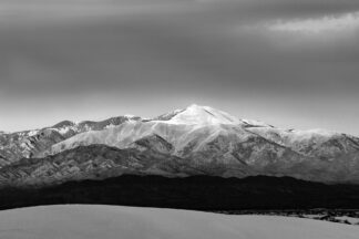 The beautiful snowy Sierra Blanca Peak was seen from White Sands National Monument in the evening sun.