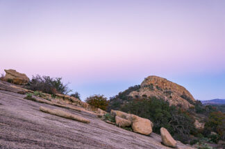 Turkey Peak was seen from a hiking trail on Enchanted Rock in the evening. Enchanted Rock is an exfoliation dome, meaning slabs of weathered granite cracked and peeled off over thousands of years and the process is still ongoing.